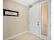 Foyer features tile floors, base trim, and front door with window at 2515 S Atlantic Ave # 1001, Daytona Beach Shores, FL 32118