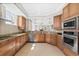 Beautiful kitchen with granite countertops, custom wood cabinetry, and stainless steel appliances at 2515 S Atlantic Ave # 1001, Daytona Beach Shores, FL 32118
