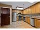 Functional kitchen with light wood cabinets, stainless steel appliances, and tile flooring, optimizing culinary experiences at 2515 S Atlantic Ave # 1001, Daytona Beach Shores, FL 32118
