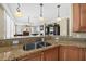 An open-concept kitchen featuring a breakfast bar with granite countertops and pendant lighting at 2515 S Atlantic Ave # 1001, Daytona Beach Shores, FL 32118
