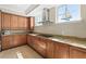 Well-lit kitchen with stainless steel hood and cooktop, custom cabinets and granite countertops at 2515 S Atlantic Ave # 1001, Daytona Beach Shores, FL 32118