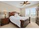 Comfortable bedroom with ceiling fan, water view through window, and elegant furnishings at 2515 S Atlantic Ave # 1001, Daytona Beach Shores, FL 32118