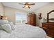 Comfortable bedroom with ceiling fan, water view through window, and elegant furnishings at 2515 S Atlantic Ave # 1001, Daytona Beach Shores, FL 32118