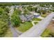 Aerial view featuring a home with manicured lawns and a screened-in pool at 2551 Cross Country Dr, Port Orange, FL 32128