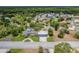 Aerial view of the property featuring a large well-maintained lot, circular driveway, and screened pool at 2551 Cross Country Dr, Port Orange, FL 32128