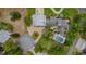 Aerial view showcases landscaped grounds, brick driveway, and a screened-in pool area at 2551 Cross Country Dr, Port Orange, FL 32128