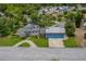 Scenic aerial of home, showcasing landscaped yard, and nearby pool area at 2551 Cross Country Dr, Port Orange, FL 32128