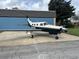 Side view of N844BC airplane parked in front of blue building with overcast sky at 2551 Cross Country Dr, Port Orange, FL 32128