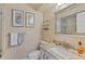 Bathroom featuring a granite countertop vanity, decorative mirror, wall art, and toilet at 2551 Cross Country Dr, Port Orange, FL 32128