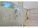 Luxurious bathroom featuring a glass shower, tiled walls, and modern fixtures, complemented by spacious vanity at 2551 Cross Country Dr, Port Orange, FL 32128