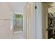 Bright bathroom showcasing a glass walk-in shower, tiled floors, and a closet, exuding a modern and clean aesthetic at 2551 Cross Country Dr, Port Orange, FL 32128