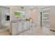 White vanity cabinet with granite countertop, large mirror and tile flooring at 2551 Cross Country Dr, Port Orange, FL 32128
