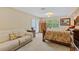 Bedroom featuring carpet flooring, double bed and door to the outside at 2551 Cross Country Dr, Port Orange, FL 32128