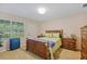 Comfortable bedroom features a window view, neutral carpet, and complemented by a well crafted wood furniture set at 2551 Cross Country Dr, Port Orange, FL 32128