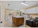 Spacious craft room features tile flooring, center island, and natural light at 2551 Cross Country Dr, Port Orange, FL 32128