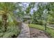 Landscaped walkway leads to the front door of this lovely home with lush tropical foliage at 2551 Cross Country Dr, Port Orange, FL 32128