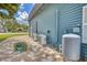 Exterior of the home showing modern HVAC system, brick patio, and well maintained landscaping at 2551 Cross Country Dr, Port Orange, FL 32128