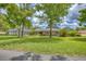 Beautiful home with lush green lawn, mature trees, and screened-in pool enclosure in the back at 2551 Cross Country Dr, Port Orange, FL 32128