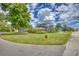 Well-manicured lawn and landscaping surround this two-story home with an oversized garage at 2551 Cross Country Dr, Port Orange, FL 32128