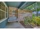 Charming front porch featuring a hanging porch swing with views of the landscaped front yard at 2551 Cross Country Dr, Port Orange, FL 32128