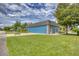 Spacious garage exterior view showcases ample parking and well-maintained landscaping at 2551 Cross Country Dr, Port Orange, FL 32128