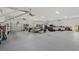 Large, well-lit garage with multiple vehicles and storage, showcasing its spaciousness at 2551 Cross Country Dr, Port Orange, FL 32128