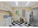 Bright kitchen features white cabinets, appliances, and a checkered tile floor that adds a unique design element at 2551 Cross Country Dr, Port Orange, FL 32128
