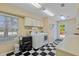 Convenient laundry room features modern appliances, ample counter space, and tiled flooring for functionality and style at 2551 Cross Country Dr, Port Orange, FL 32128