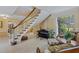 Cozy living room features a piano, seating, and staircase, creating an inviting space at 2551 Cross Country Dr, Port Orange, FL 32128
