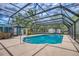 Inviting screened-in pool area with comfortable seating perfect for relaxation and entertaining at 2551 Cross Country Dr, Port Orange, FL 32128