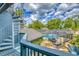 Outdoor pool area featuring a screened-in pool, rock waterfall feature, and beautiful landscaping at 2551 Cross Country Dr, Port Orange, FL 32128