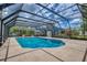 The large screened-in pool area offers an inviting and relaxing atmosphere with plenty of space to unwind at 2551 Cross Country Dr, Port Orange, FL 32128