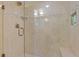 Bathroom shower with glass door and tile surround; niche with storage for toiletries at 2551 Cross Country Dr, Port Orange, FL 32128