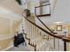 Elegant curved staircase with wooden handrail and white spindles, creating a welcoming and grand entryway at 2551 Cross Country Dr, Port Orange, FL 32128