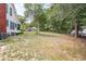 Spacious backyard, surrounded by mature trees and partial fencing at 257 Huntington Dr, Deland, FL 32724