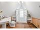 Bright bathroom featuring glass shower, white walls, wood floors, and built-in shelving at 257 Huntington Dr, Deland, FL 32724