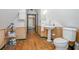 Traditional bathroom featuring pedestal sink, wood floors and paneled walls at 257 Huntington Dr, Deland, FL 32724