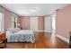 Cozy bedroom with hardwood floors and a comfortable queen-sized bed at 257 Huntington Dr, Deland, FL 32724
