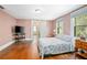 Bedroom with hardwood floors, window and a cozy queen-sized bed at 257 Huntington Dr, Deland, FL 32724