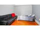 A bedroom featuring hardwood floors, a sofa, a twin bed, and ample natural light at 257 Huntington Dr, Deland, FL 32724