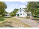 Charming two-story home with white siding, a green awning, and a long driveway at 257 Huntington Dr, Deland, FL 32724