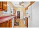 Traditional-style kitchen featuring wood cabinets, laminate countertops, and modern appliances at 257 Huntington Dr, Deland, FL 32724