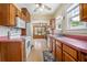 Functional kitchen with ample wood cabinetry, stainless steel sink, and views into the adjacent living areas at 257 Huntington Dr, Deland, FL 32724