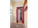 A laundry room area with a stacked washer and dryer, shelving, and a window for natural light at 257 Huntington Dr, Deland, FL 32724