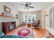 Inviting living room featuring hardwood floors, classic ceiling fan, fireplace, and large windows at 257 Huntington Dr, Deland, FL 32724