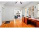 Inviting home office with hardwood floors, classic trim, an adjacent room and view into the living room at 257 Huntington Dr, Deland, FL 32724