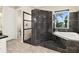 Bathroom features tiled shower, whirlpool tub and picture window with palm tree views at 2636 S Peninsula Dr, Daytona Beach, FL 32118
