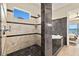 Bathroom features tiled shower, whirlpool tub and access to bedroom with waterfront views at 2636 S Peninsula Dr, Daytona Beach, FL 32118