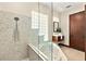 Elegant bathroom featuring a marble soaking tub, glass shower, and a modern vanity with a wood cabinet at 2636 S Peninsula Dr, Daytona Beach, FL 32118