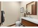 Powder room featuring vanity with drawer storage, modern fixtures and fixtures and wall art at 2636 S Peninsula Dr, Daytona Beach, FL 32118